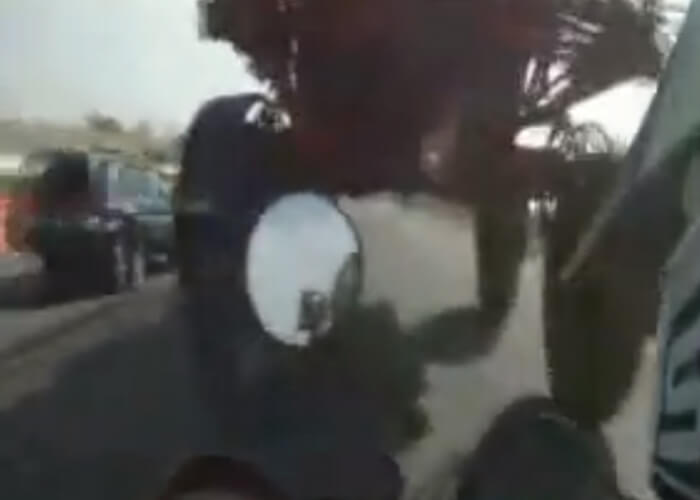 VIDEO: Stupid Motorcyclist Drives Under Tractor