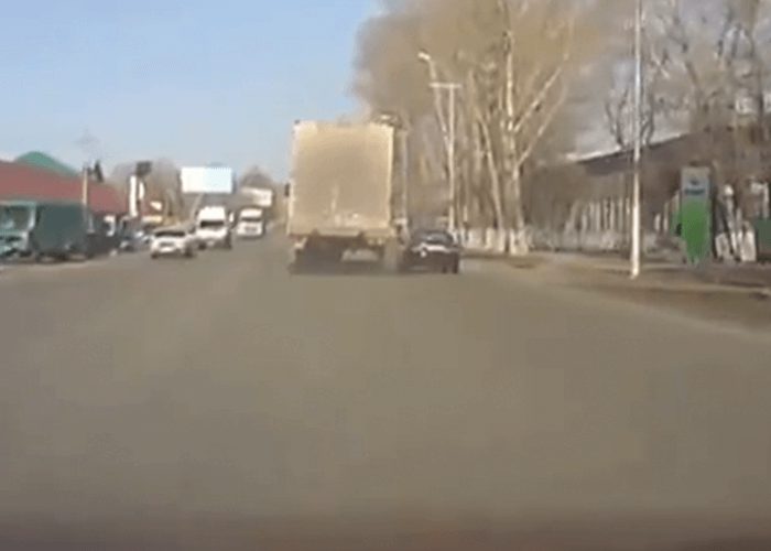 VIDEO: Car Tries To Squeeze By Truck