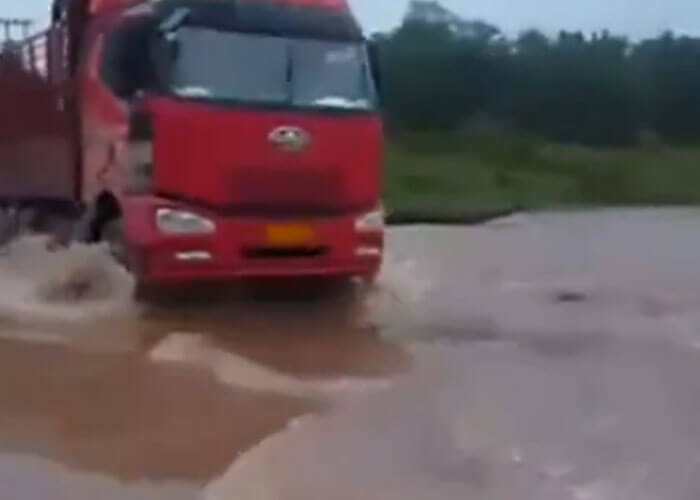 VIDEO: Truck Driver Thinks He Can Make It Through Flood Waters