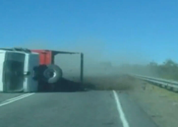 VIDEO: Truck Overturns, Spilling Rock Across the Highway