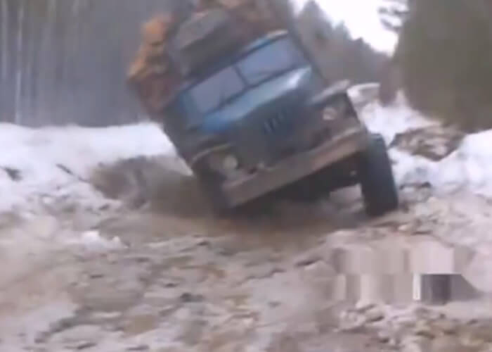 VIDEO: Overloaded Truck Overturns In A Siberian Highway