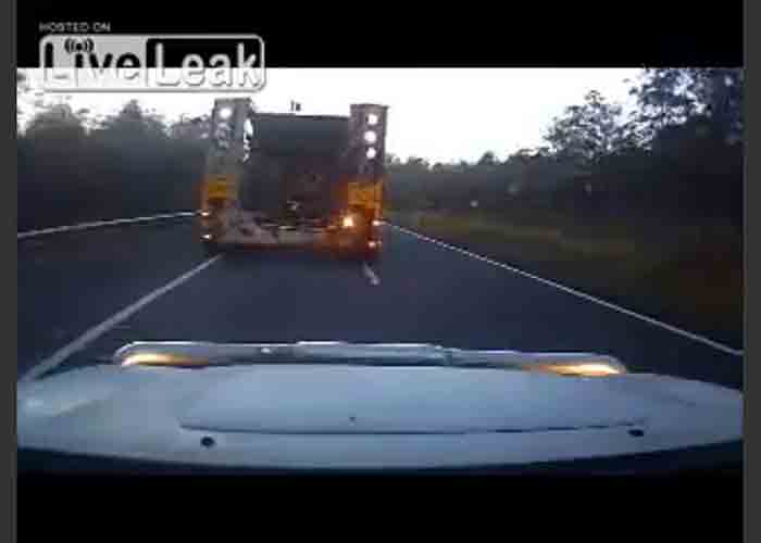 VIDEO: Car Attempts To Squeeze Past A Wide Load