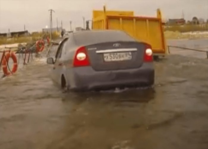 VIDEO: Truck Driver Crosses Flood On Bridge