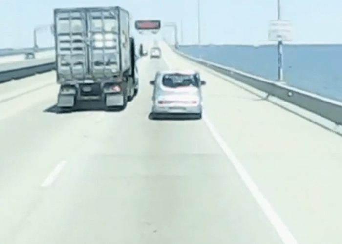 VIDEO: Car Passes Truck On Right, Nearly Causes Crash