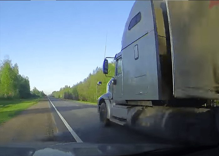 VIDEO: Car Tries To Pass Truck, Gets Forced Onto Shoulder