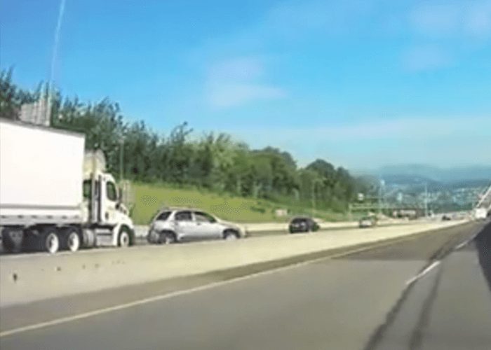 VIDEO: Car Clips Truck, Smashes Into Barrier