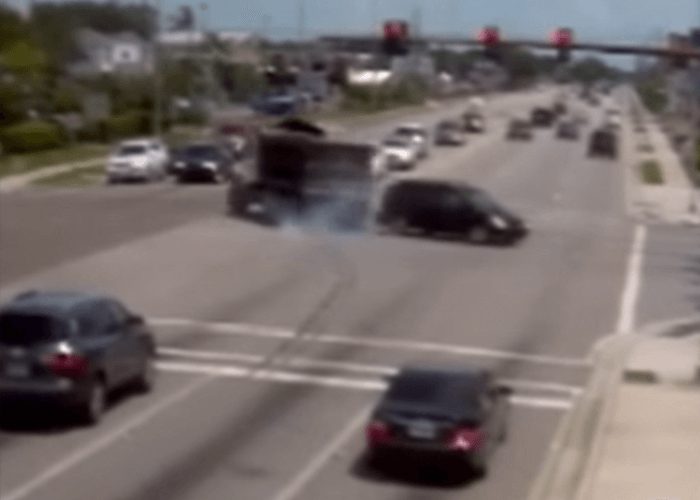 VIDEO: Dump Truck’s Runs Red Light, Almost Hits Building