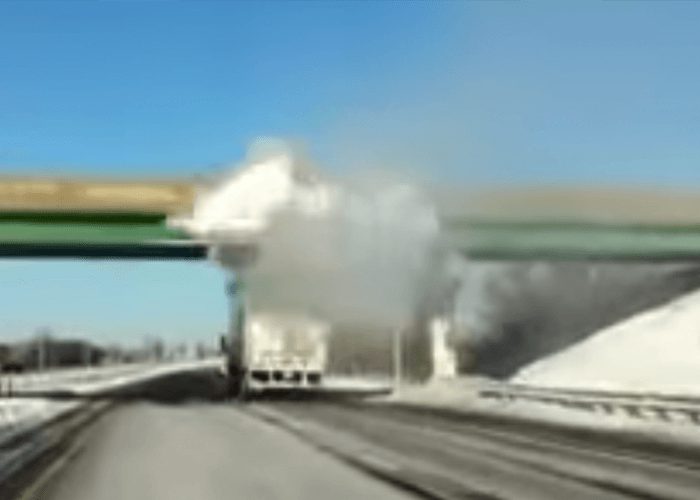 VIDEO: Snow On Top Of Truck Explodes As It Collides With Bridge