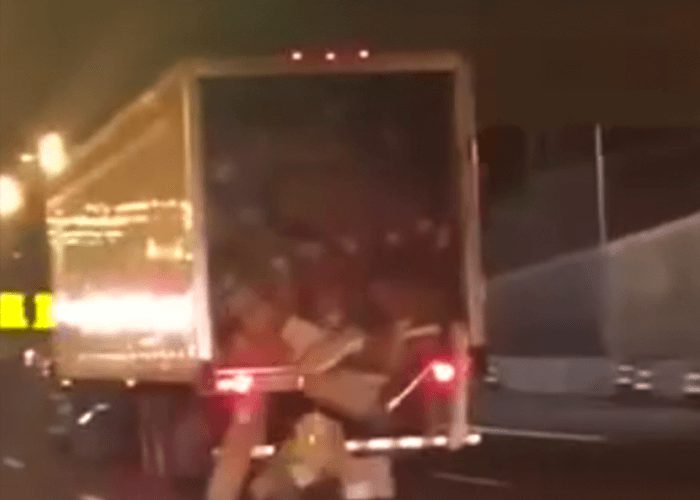 VIDEO: Truck Unloads Boxes Onto Highway