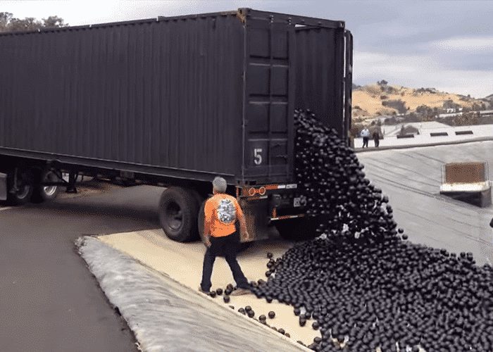 VIDEO: Tons Of Hypnotic Black Shade Balls Tumble Out Of Truck