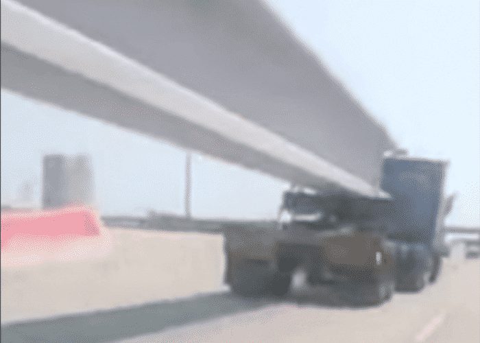 VIDEO: Insane Driver Goes Under Oversized Load