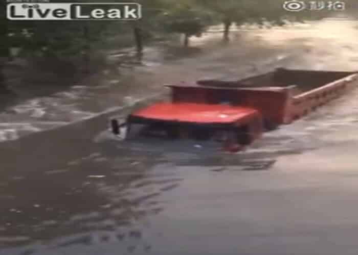 VIDEO: Truck Plows Through Flooded Road