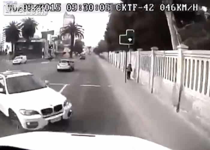 VIDEO: BMW Driver Hits Truck Head On, Sends Pedestrian Running