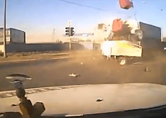 VIDEO: Car Trailer Launched Into Truck By Crazy Intersection Accident