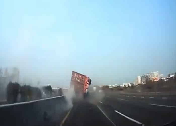 VIDEO: Truck Topples Onto Two Cars