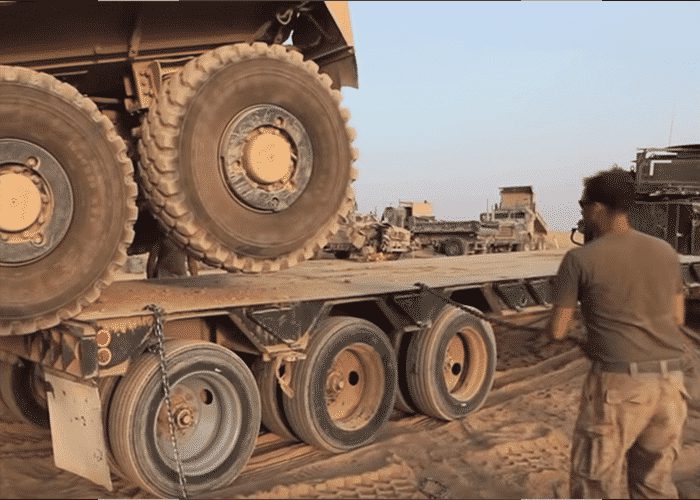 VIDEO: Extreme Machines Work Together To Flatbed Military Truck