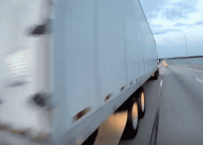 VIDEO: Motorcyclist “Pets” Truck On Highway