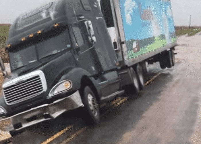 VIDEO: Texas Flooding Leaves Truck Stuck With Wheels In The Air