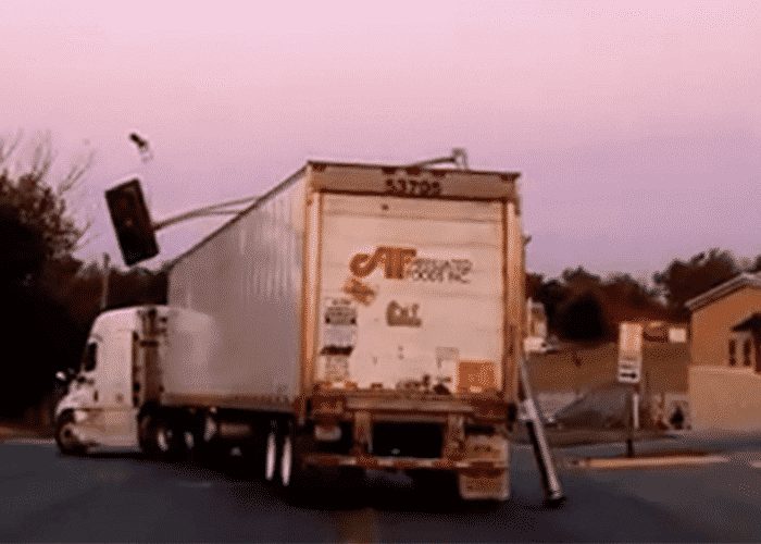 VIDEO: Truck Driver Clueless About Giant Traffic Light Hanging From Rig