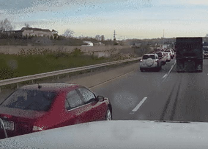 VIDEO: Red Car Almost Clips Truck