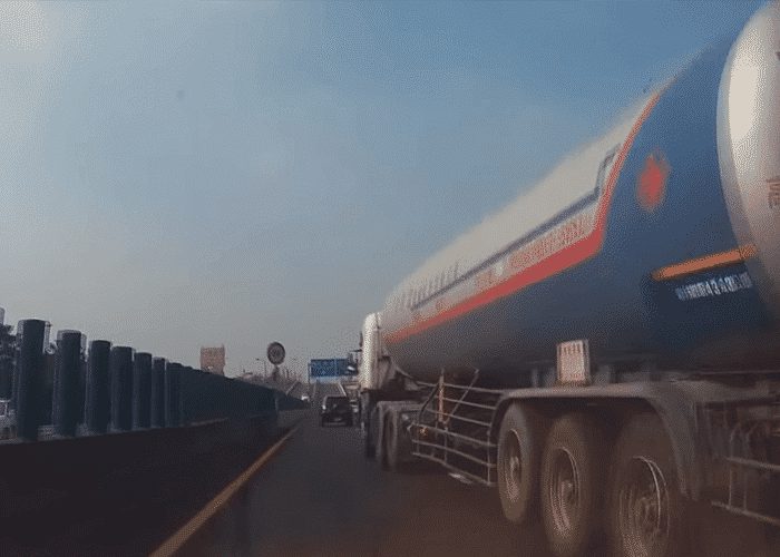 VIDEO: Car Sandwiched Between Truck And Concrete Barrier