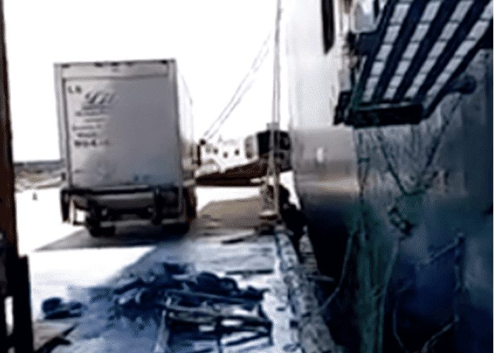 VIDEO: Falling Pallet Of Blue Paint Narrowly Misses Two Trucks