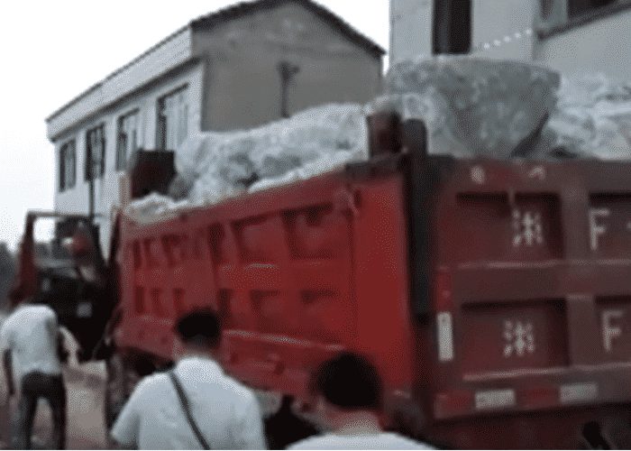 VIDEO: Fearless Truckers Plunge Rigs Full Of Rocks Into Dam Breech To Stop Flooding