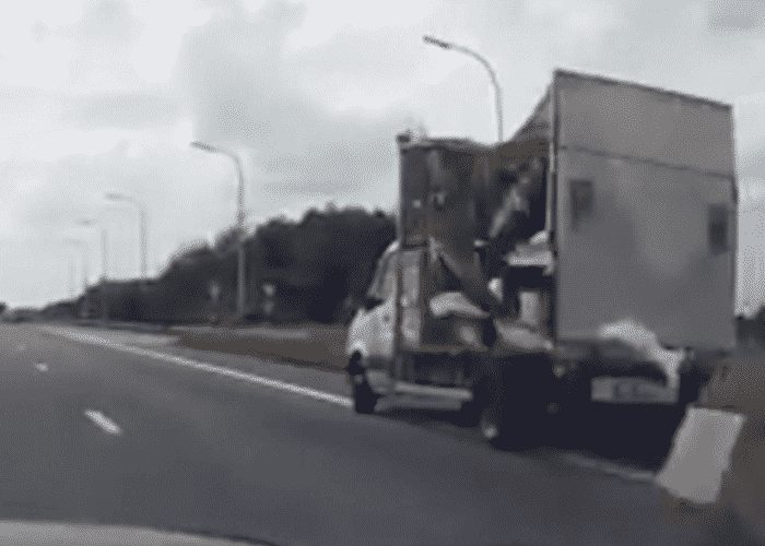 VIDEO: Side Panel Of Box Truck Falls Off And Hits Cammer