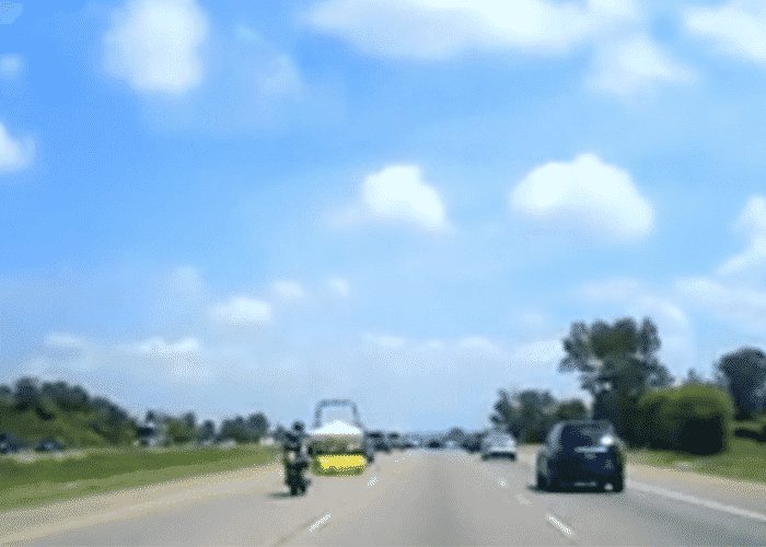 VIDEO: Unsecured Load Sends Motorcyclist Soaring