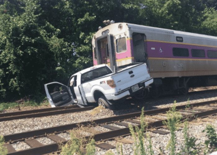 VIDEO: Pickup Drives Through Gate And Gets Dragged By Train