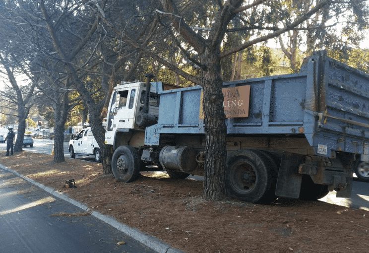Driver Crashes Runaway Dump Truck Into Tree To Avoid Hitting Cars