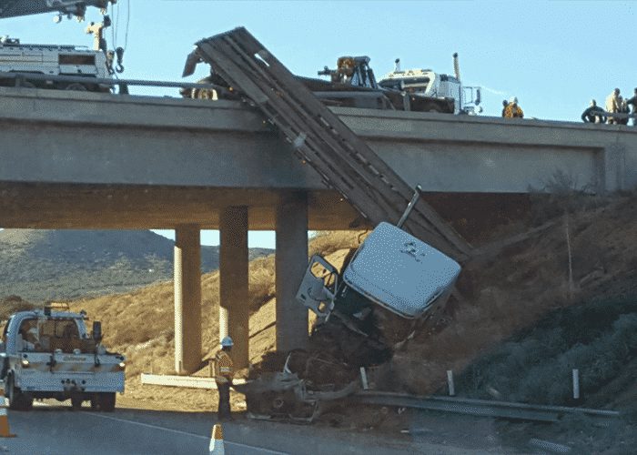 Crash Leaves Truck Dangling From Overpass