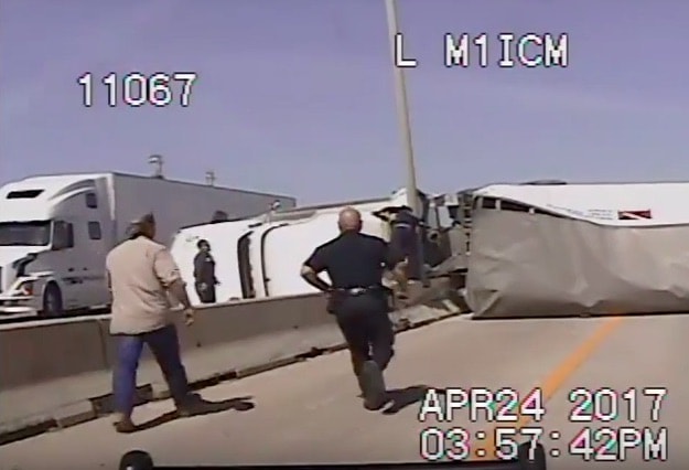 VIDEO: Police And Bystanders Race To The Aid Of Trucker After Rollover