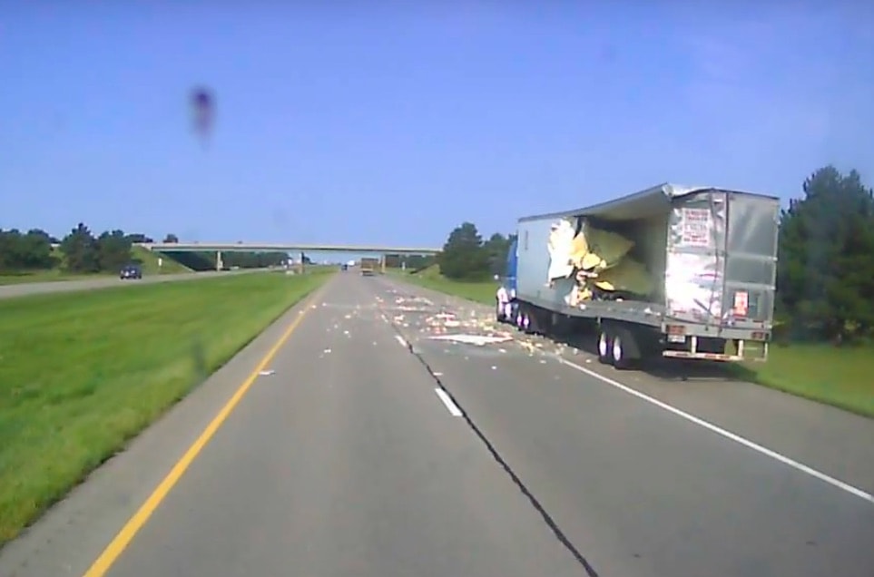 VIDEO: Oversized load guts parked truck’s trailer