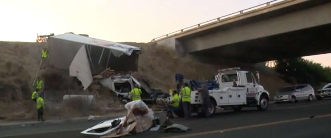 FedEx truck driver dies after sedan passes on the right, sending truck flying off overpass