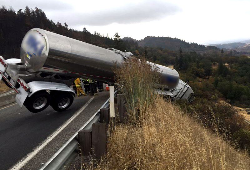 Truck clings to guardrail while dangling over the road’s edge