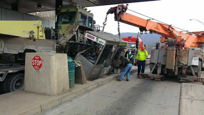 One hurt after oversized load rips toll booth from foundation