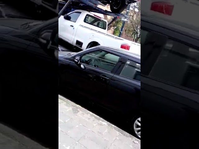 VIDEO: Car hauler drags parked car while turning