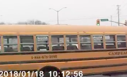 VIDEO: Dangerous school bus driver cuts across three lanes in front of truck