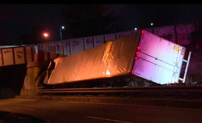 Semi truck severely wedged under Boston railroad overpass