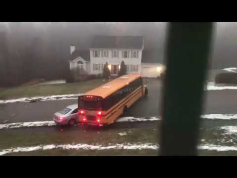 VIDEO: School bus full of kids slides backwards down slick hill