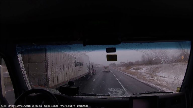 VIDEO: Trucker tailgates car inches away in winter storm