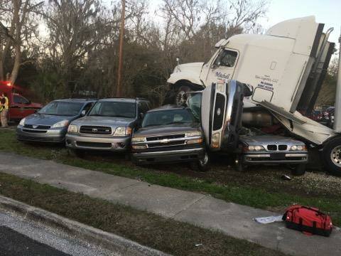 Truck runs over multiple cars at used auto dealership
