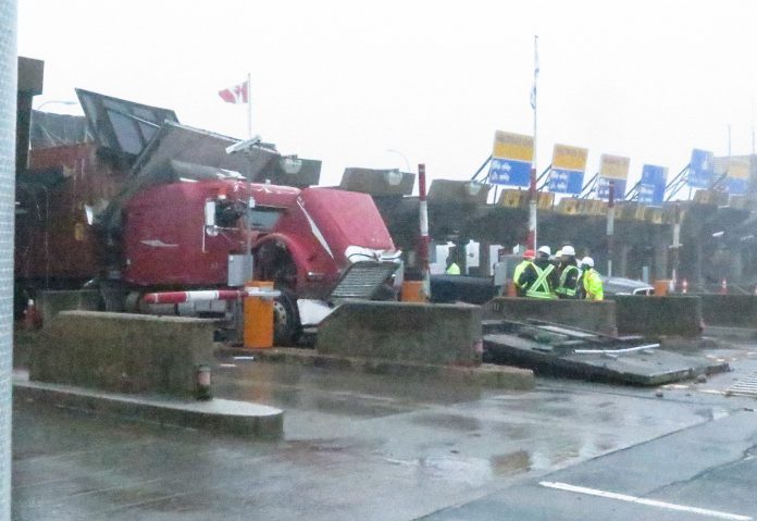 Truck tries to go through toll booth car lane, causes serious damage