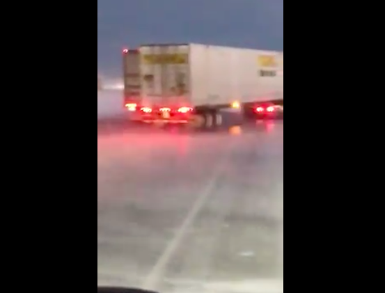 VIDEO: Wind whips trailer into passing truck