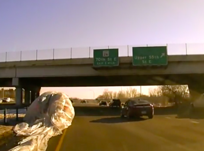 VIDEO: Plastic sheet falls off dump truck, eats SUV whole