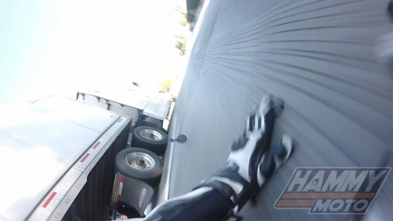 VIDEO: Motorcyclist crashes under semi truck, somehow walks away