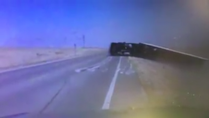 Trooper captures Kansas winds toppling truck on dash cam