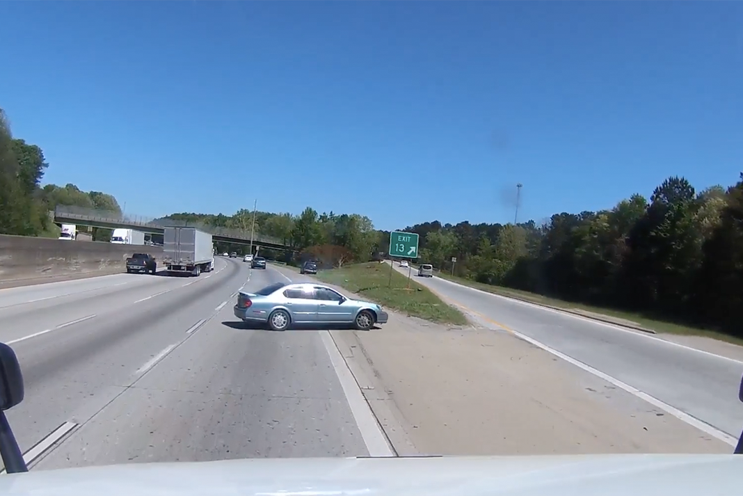 VIDEO: Car driver would rather get hit by a truck than miss his exit