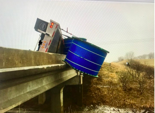 Sideswipe leaves trucker in precarious position